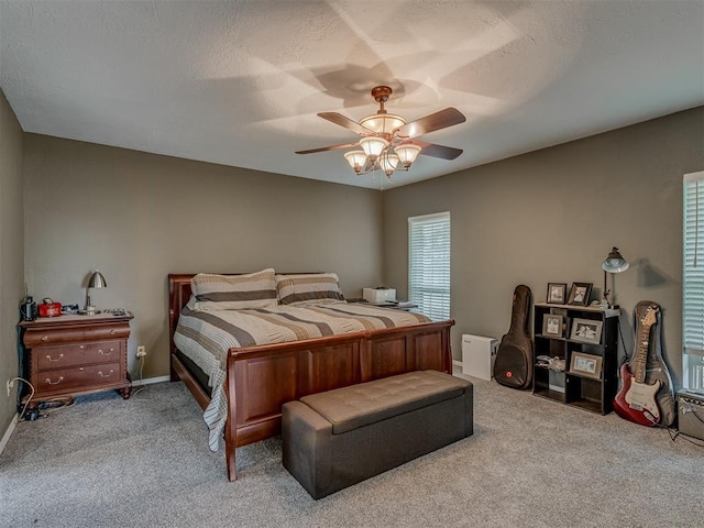 carpeted bedroom with baseboards and ceiling fan