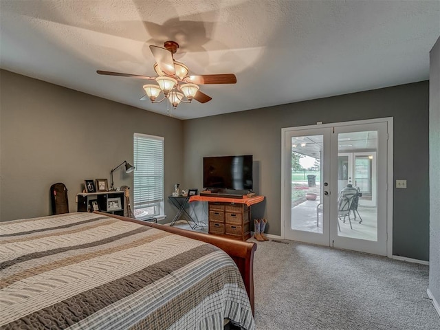bedroom featuring carpet floors, access to outside, multiple windows, and french doors