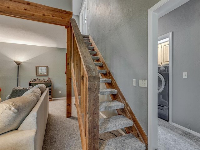 stairway featuring baseboards, a textured wall, and carpet