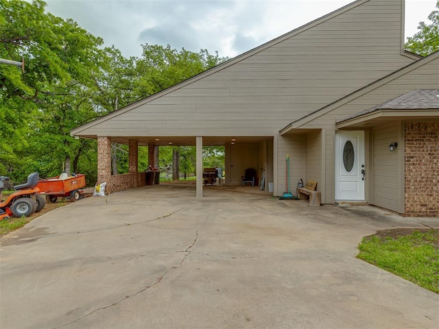 view of car parking with concrete driveway and a carport