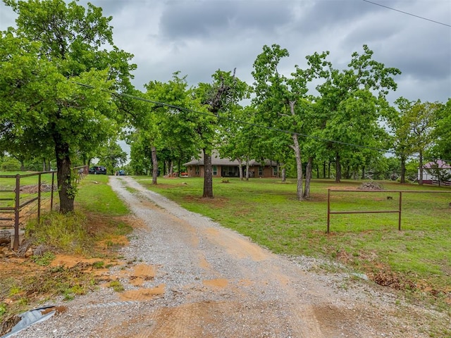 view of road with gravel driveway