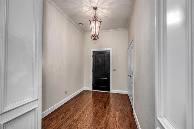 entrance foyer featuring crown molding, dark wood-style flooring, baseboards, and visible vents