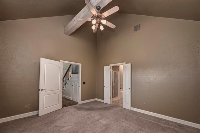 unfurnished bedroom with visible vents, baseboards, ensuite bathroom, high vaulted ceiling, and carpet flooring
