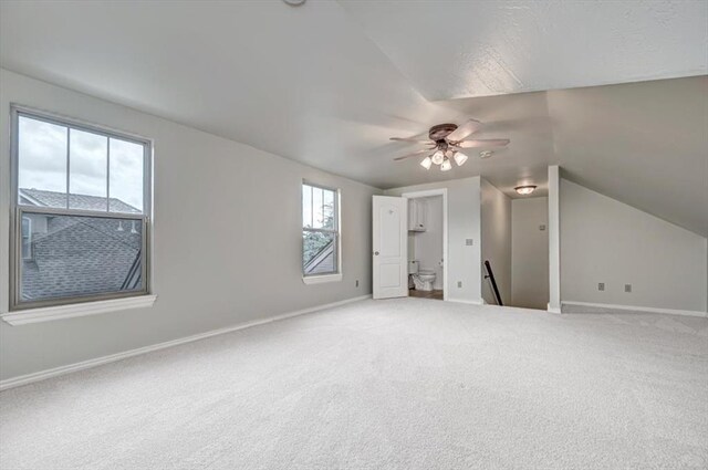 bonus room with baseboards, a ceiling fan, vaulted ceiling, and carpet floors