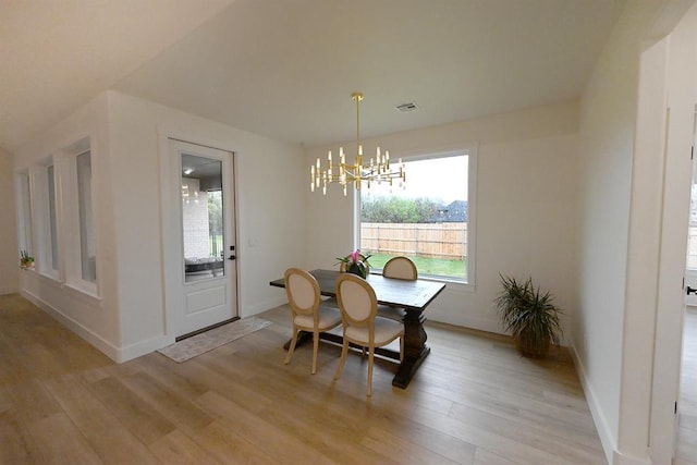 dining area with visible vents, baseboards, an inviting chandelier, and light wood finished floors