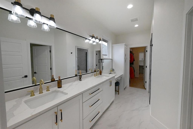 full bathroom with a sink, a walk in closet, recessed lighting, and double vanity