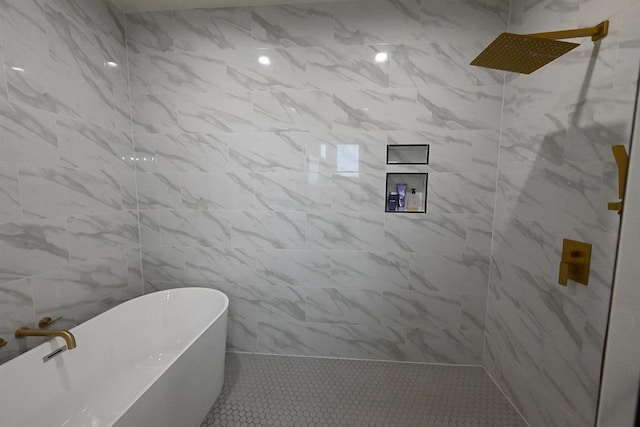 bathroom featuring a freestanding tub, tiled shower, and tile patterned flooring