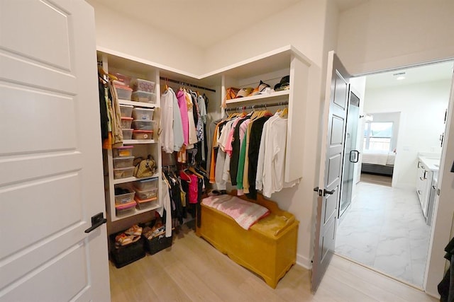 spacious closet featuring marble finish floor