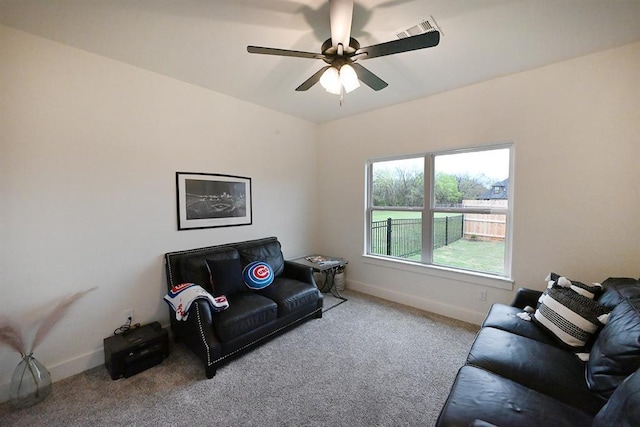 living area featuring carpet flooring, a ceiling fan, baseboards, and visible vents