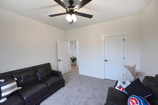 living area with ceiling fan, baseboards, and carpet