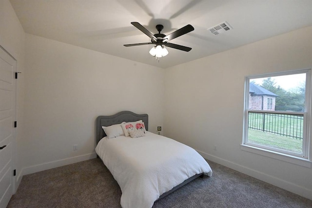 carpeted bedroom featuring baseboards, visible vents, and ceiling fan