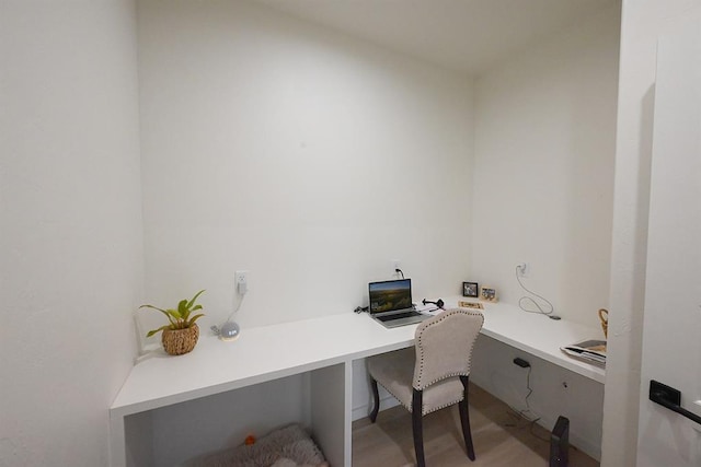 office featuring light wood-style floors and built in study area