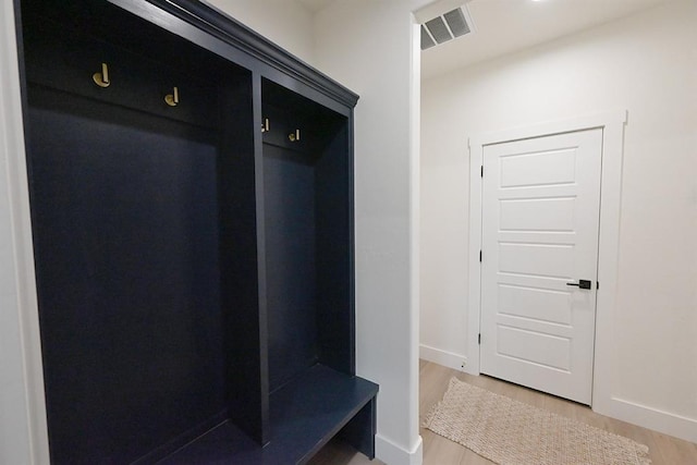 mudroom featuring baseboards, visible vents, and light wood-style flooring