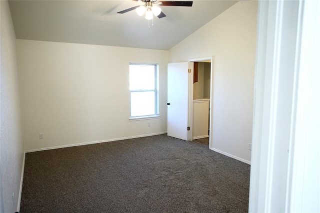 spare room with ceiling fan, baseboards, lofted ceiling, and dark colored carpet