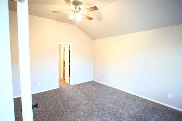 carpeted spare room with baseboards, ceiling fan, and vaulted ceiling