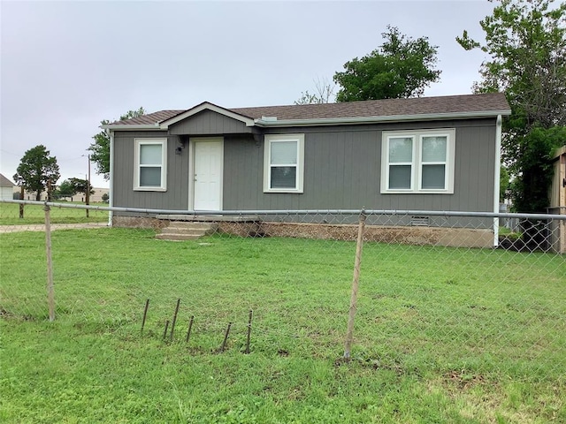 manufactured / mobile home with fence, entry steps, and a front yard