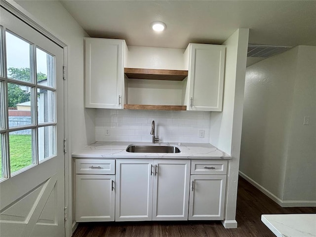 kitchen featuring open shelves, a sink, dark wood-style floors, and white cabinetry