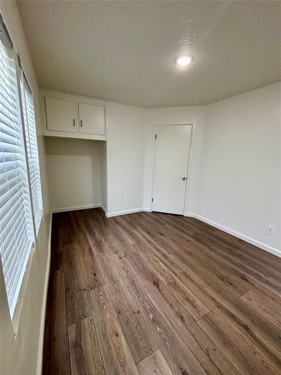 interior space featuring recessed lighting, baseboards, and wood finished floors