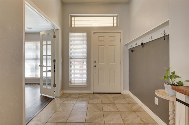 entryway with baseboards and visible vents