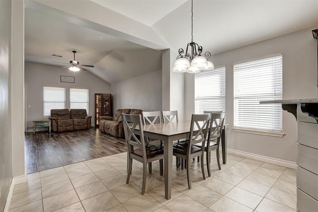 dining space featuring visible vents, baseboards, vaulted ceiling, and ceiling fan with notable chandelier