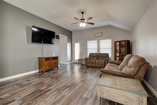 living area featuring baseboards, a ceiling fan, lofted ceiling, and wood finished floors