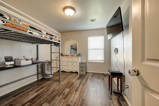 bedroom featuring baseboards, dark wood-style flooring, and visible vents