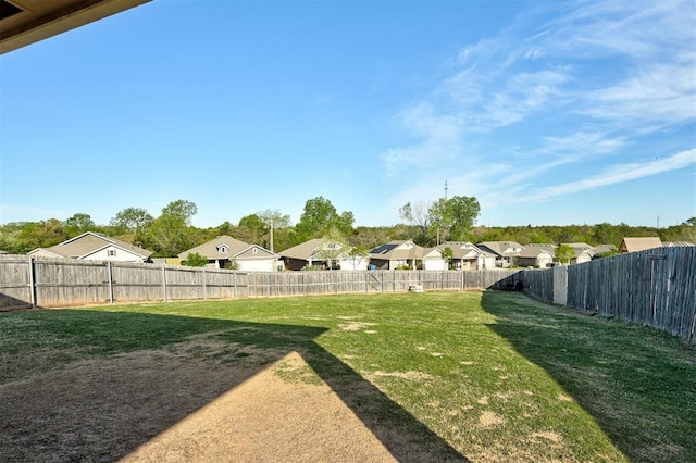 view of yard with a residential view and a fenced backyard