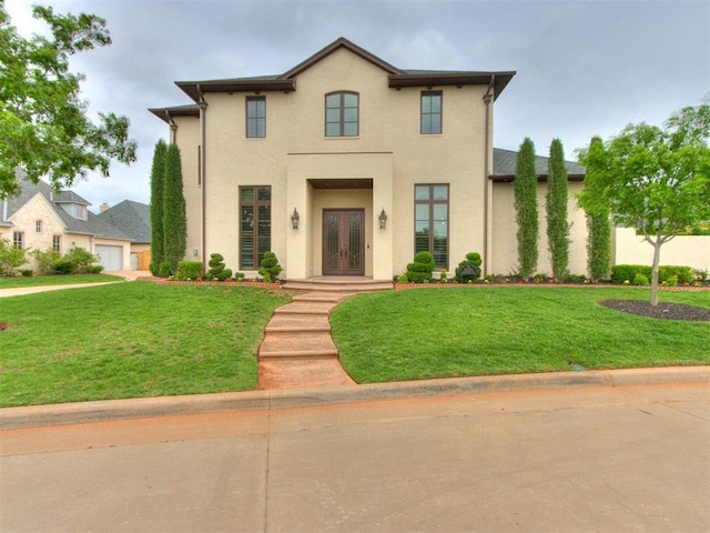 view of front facade featuring a front lawn, stucco siding, and french doors