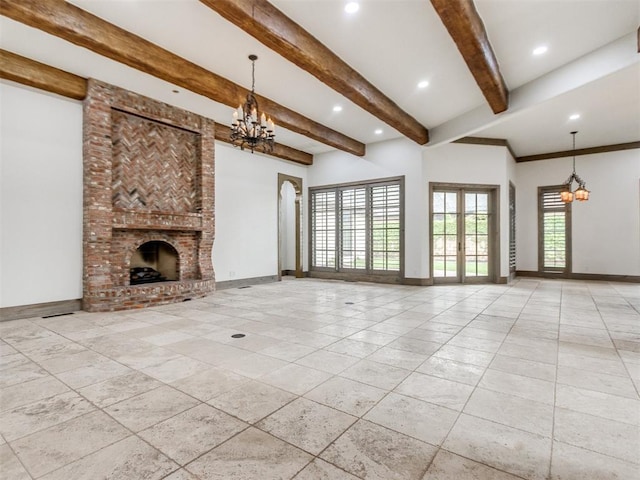 unfurnished living room featuring an inviting chandelier, baseboards, a fireplace, and beam ceiling