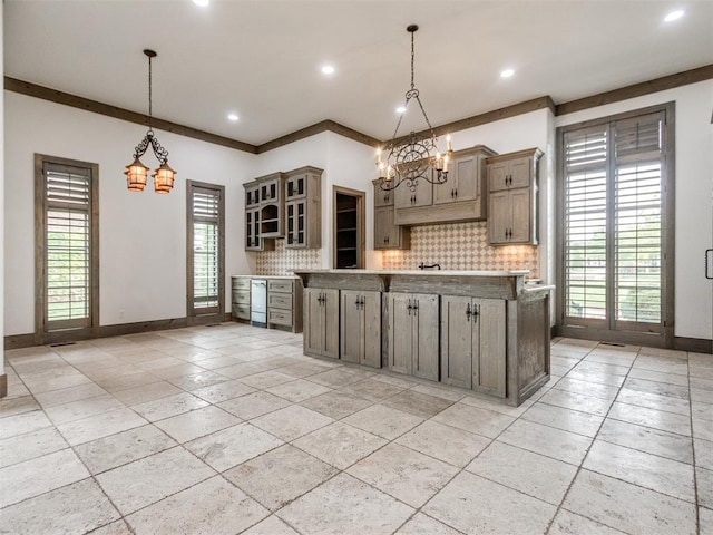 kitchen featuring baseboards, decorative backsplash, and a chandelier