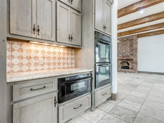 kitchen with dobule oven black, decorative backsplash, beam ceiling, a fireplace, and light countertops
