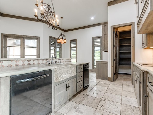 kitchen featuring black dishwasher, recessed lighting, a sink, a notable chandelier, and decorative light fixtures