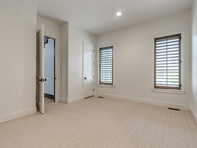 unfurnished bedroom featuring baseboards, carpet, recessed lighting, and visible vents