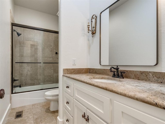 full bathroom featuring vanity, bath / shower combo with glass door, toilet, and visible vents