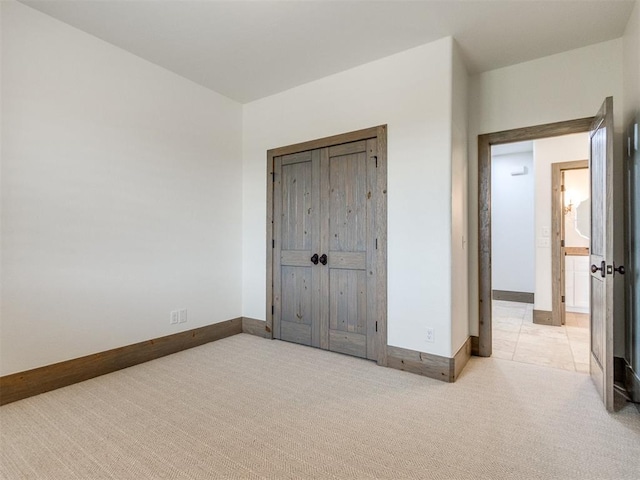 unfurnished bedroom featuring carpet floors and baseboards