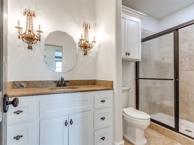 full bathroom with vanity, an inviting chandelier, toilet, tile patterned floors, and a stall shower