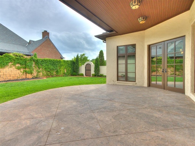 view of patio / terrace with an outbuilding, french doors, and a storage unit