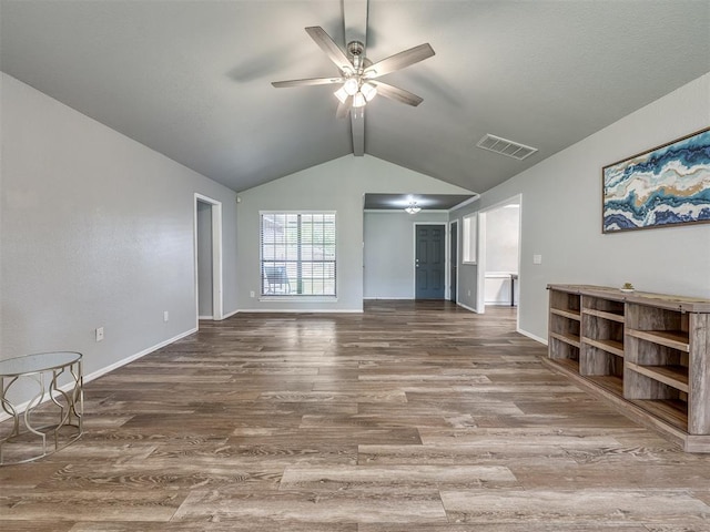 unfurnished living room featuring a ceiling fan, baseboards, wood finished floors, lofted ceiling, and visible vents