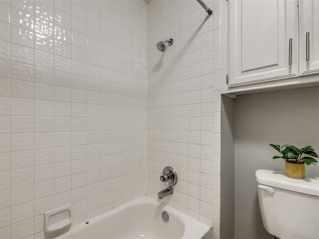 bathroom featuring shower / bath combination and toilet