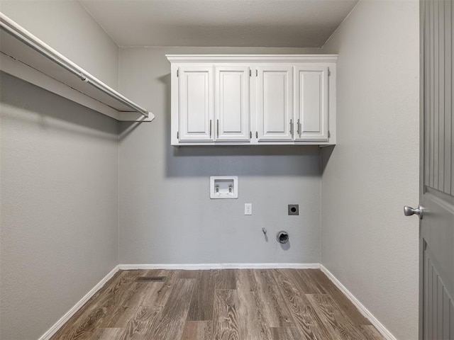 clothes washing area featuring washer hookup, hookup for an electric dryer, hookup for a gas dryer, and dark wood-style flooring