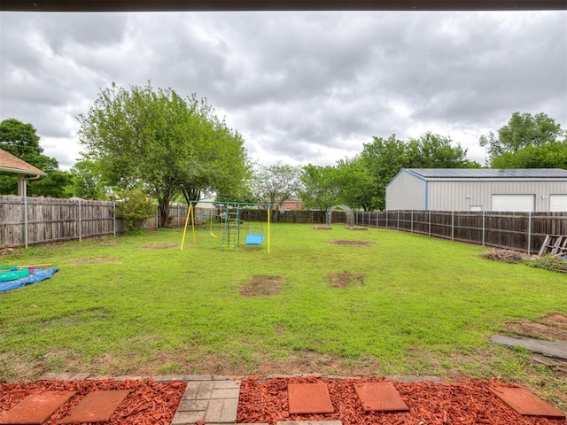 view of yard with a fenced backyard and a playground