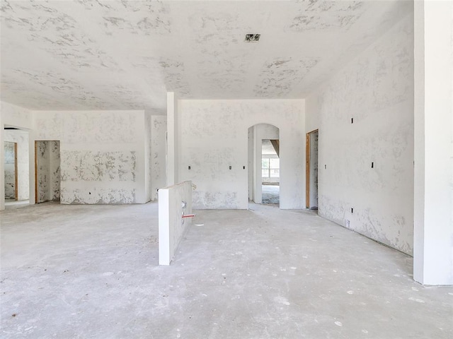 11673 Ward Rd, Edmond, OK 73034 - unfurnished living room featuring arched walkways
