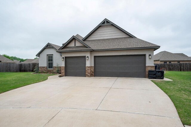 craftsman inspired home featuring fence, an attached garage, stucco siding, and a front yard
