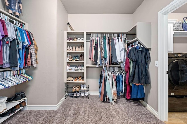 walk in closet with washer / clothes dryer and carpet floors