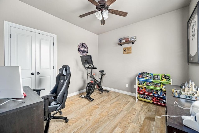 home office with baseboards, a ceiling fan, and wood finished floors