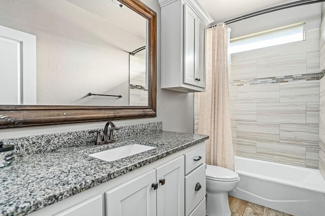 bathroom with vanity, shower / tub combo, and toilet