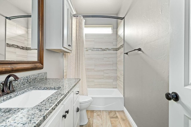 bathroom with vanity, baseboards, toilet, and shower / tub combo with curtain