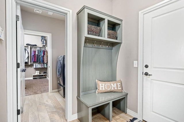 mudroom featuring baseboards and washer / dryer
