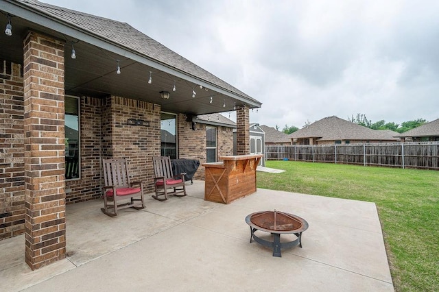 view of patio featuring a fenced backyard and a fire pit