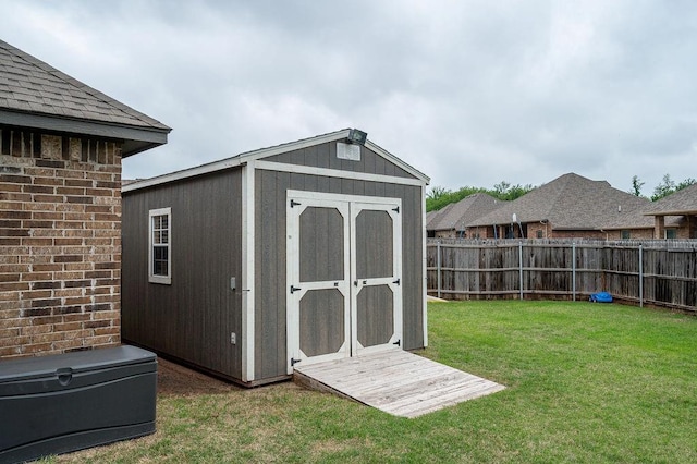 view of shed with a fenced backyard